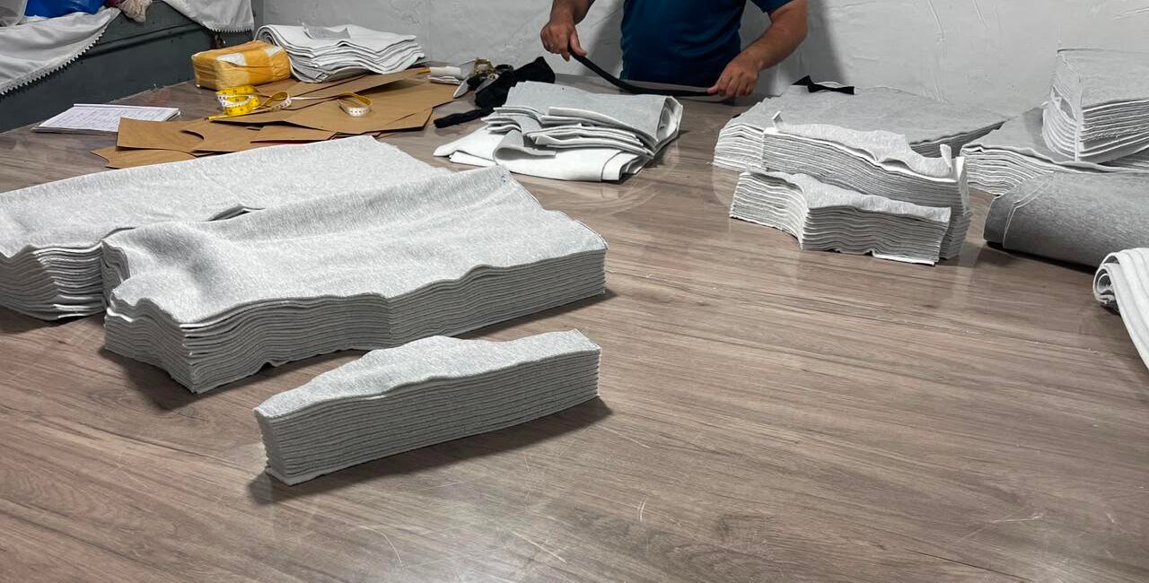 Fabric cutting process at Wearlets custom clothing manufacturing facility
