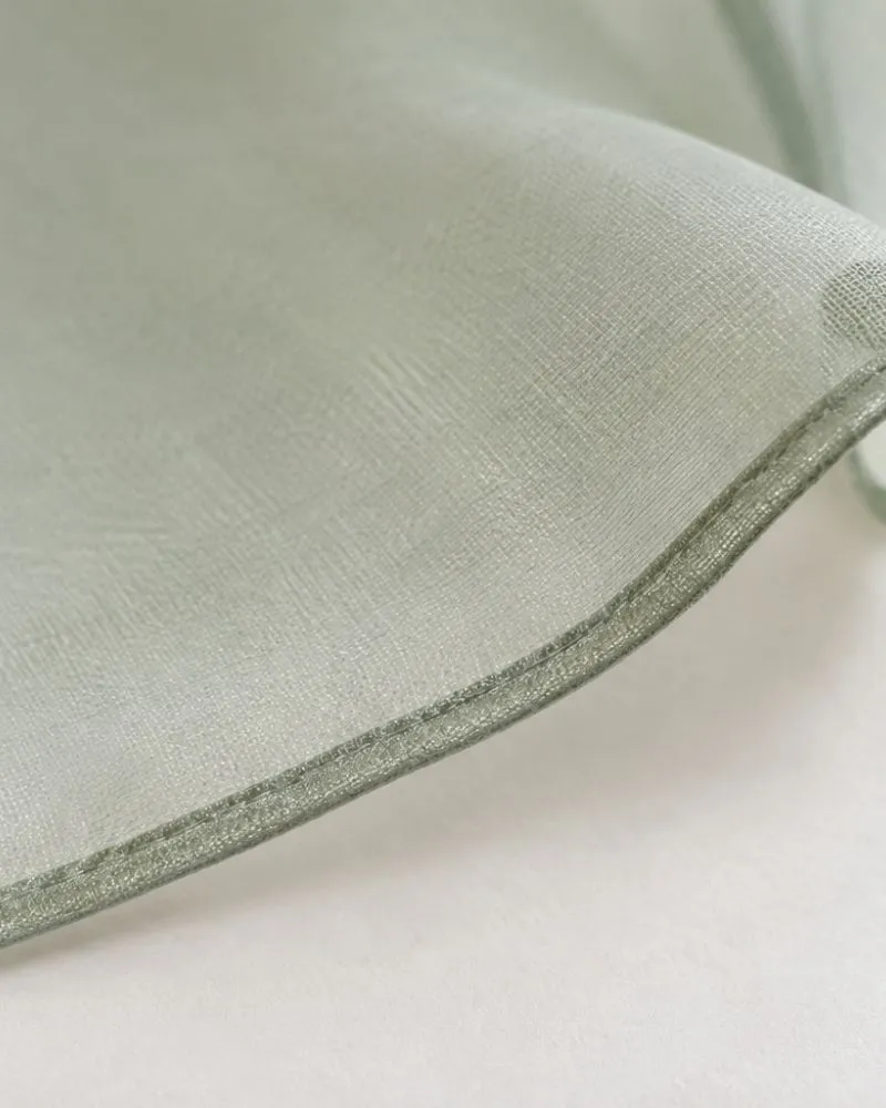 Close-up of a narrow rolled hem on lightweight chiffon fabric